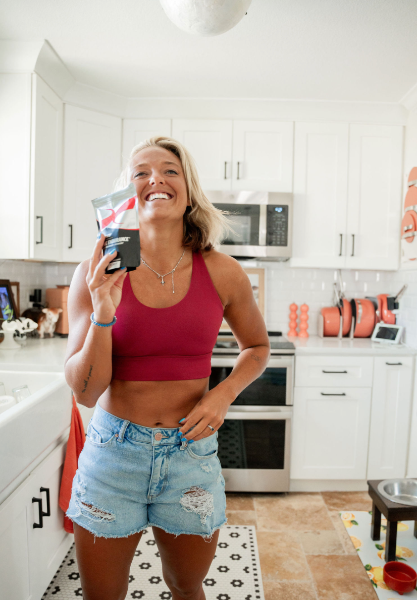 A vibrant morning kitchen scene featuring a healthy breakfast spread with fresh fruits, nuts, a smoothie, and a bottle of fitness supplements.